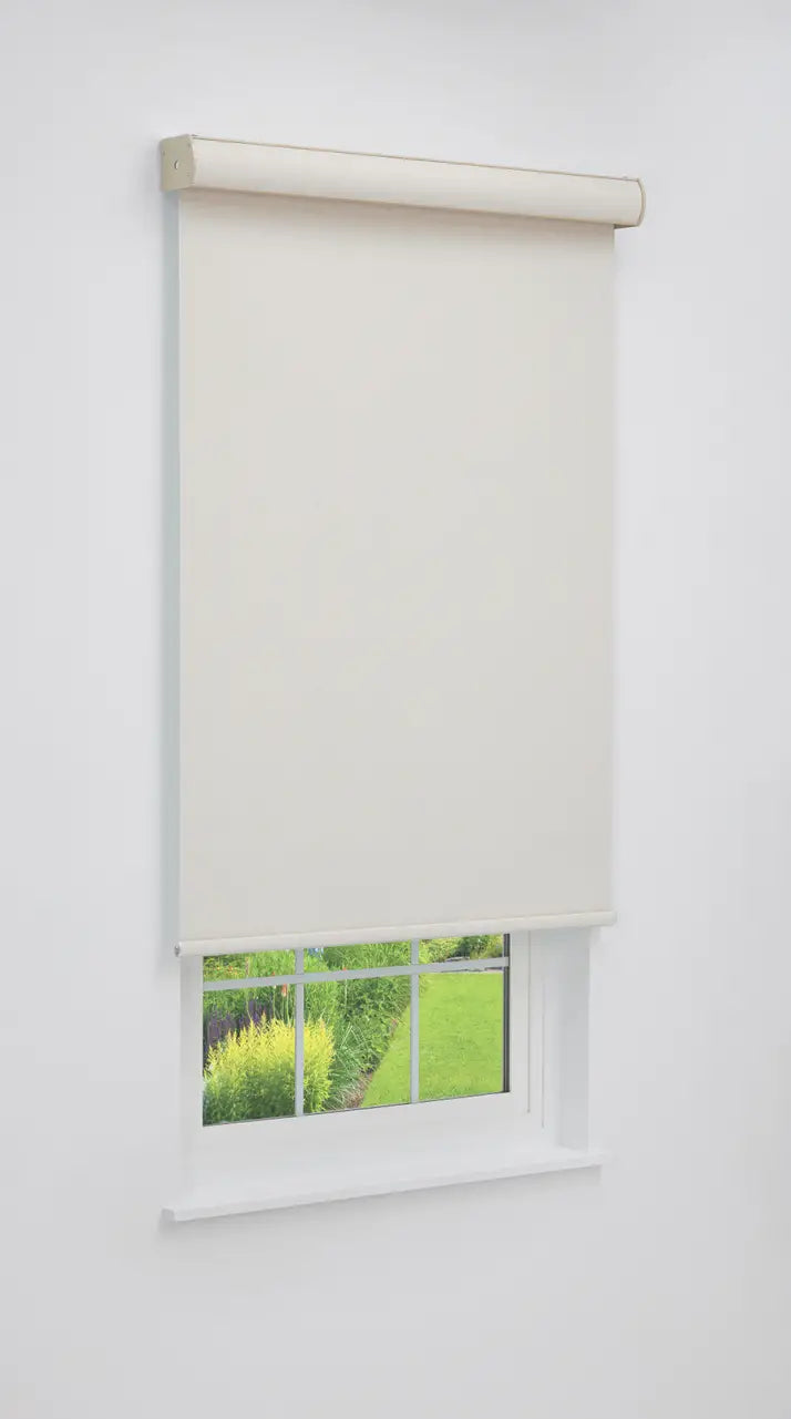Coastal Blackout Roller Shade in Sandbar Cream mounted on a window, angled room view