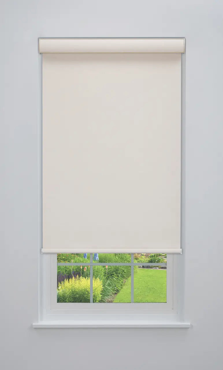 Coastal Blackout Roller Shade in Sandbar Cream, front view on window