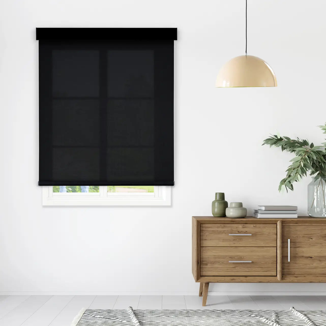 1% Solar Screen Roller Shade in black, styled in a living room above a wood console table